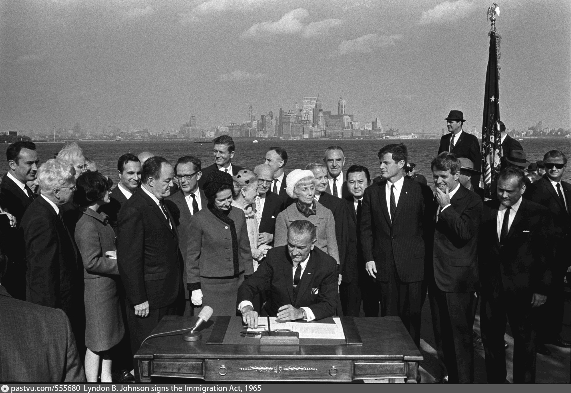 President Lyndon B Johnson Signs The Immigration Act At The Foot Of 