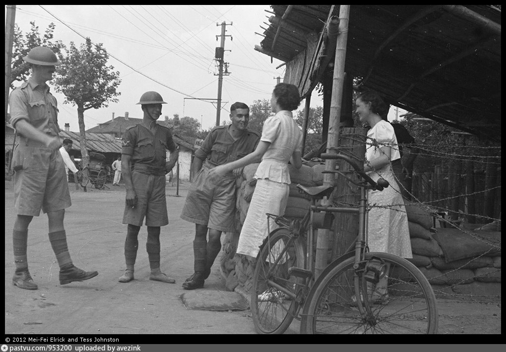 Women and British soldiers chatting at a guard post