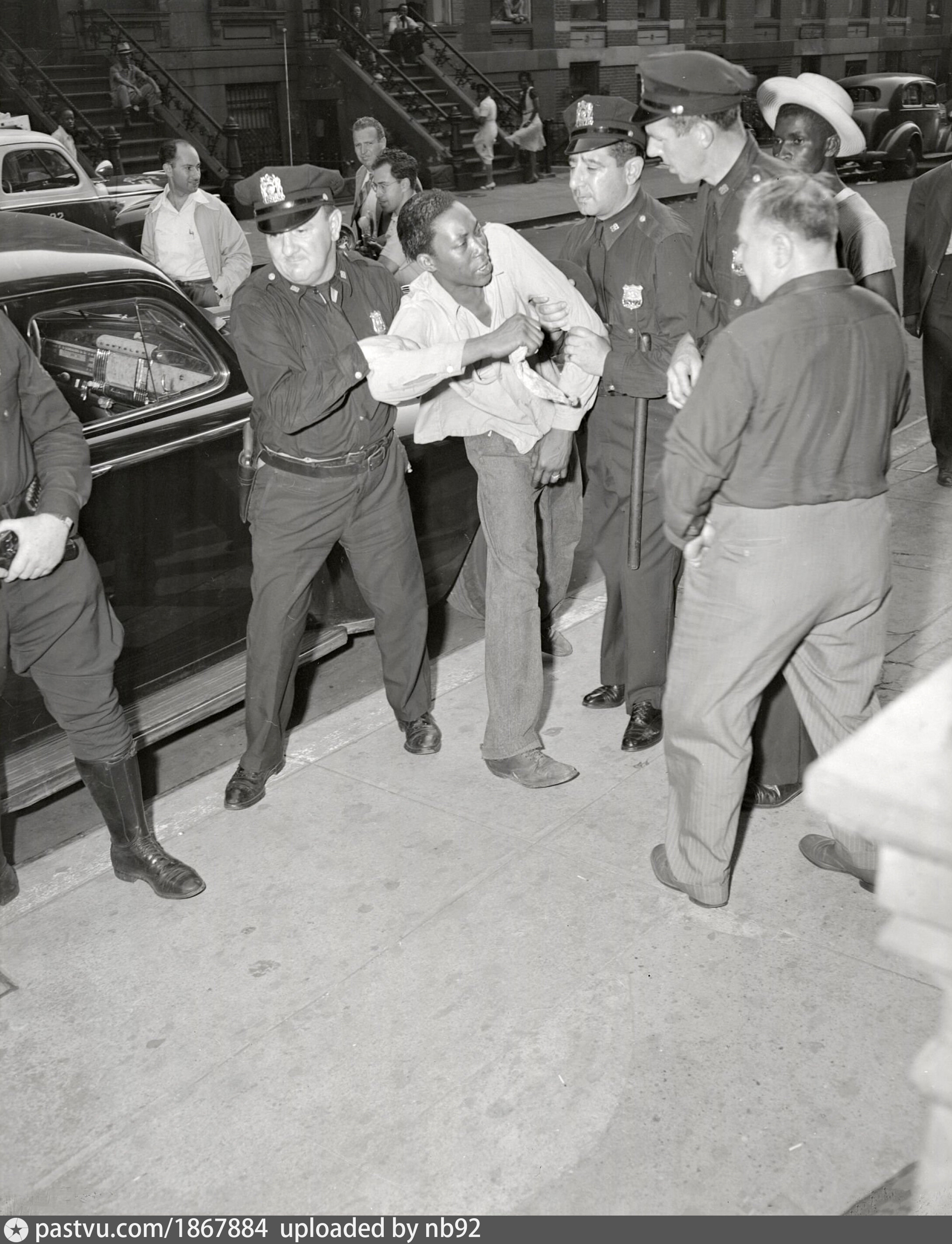 Police officers arrest man in Harlem Riots