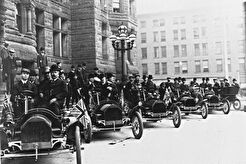 Line of Russell cars sitting outside City Hall (1909)