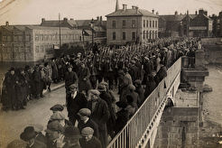 British soldiers walk across the bridge at Athlone after handing over the barracks to Ireland (1922)